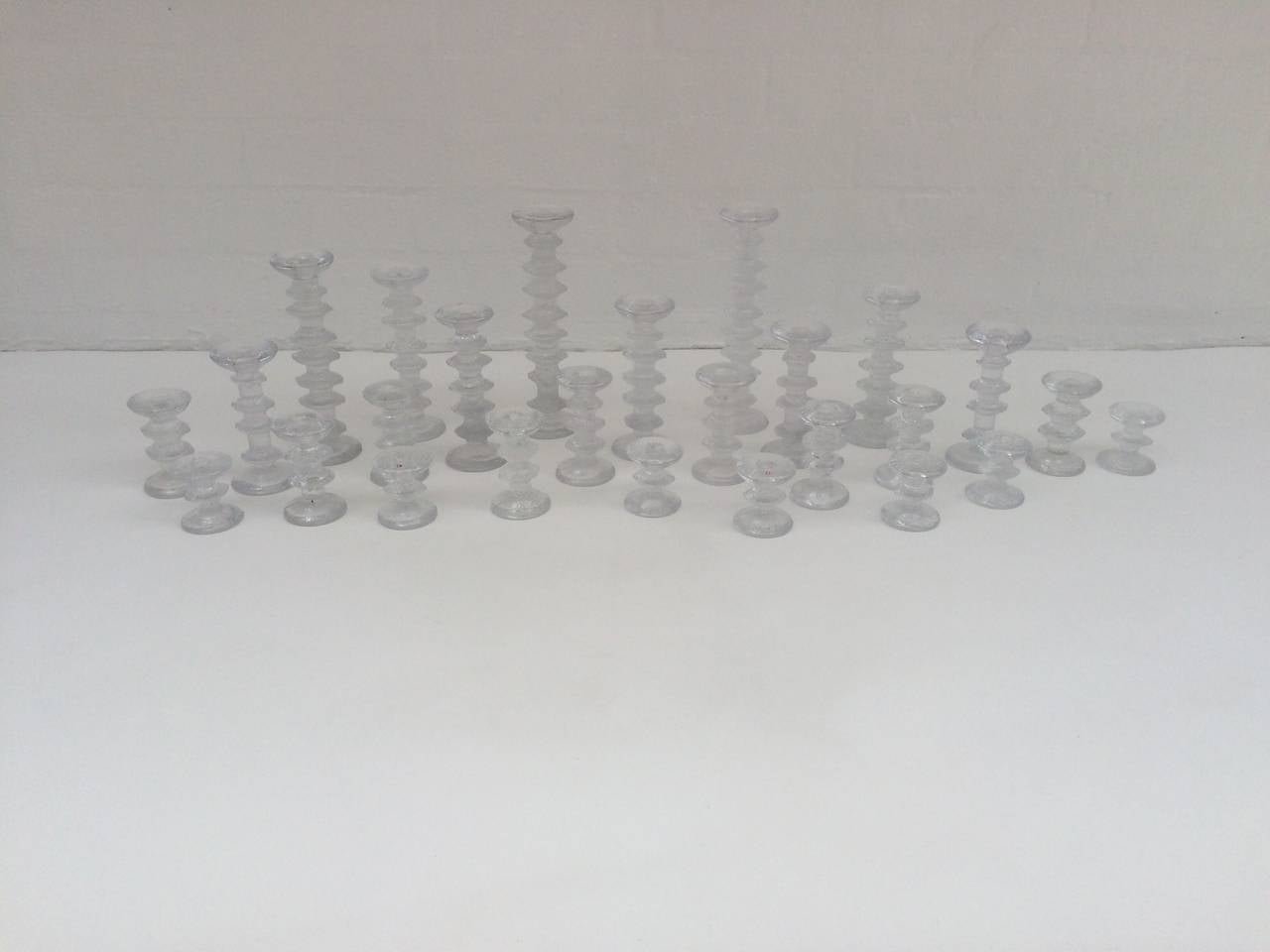 Collection of 33 different size Festivo glass candleholders designed by Timo Sarpaneva 
made for Iittala of Finland. 
Sizes range from 3