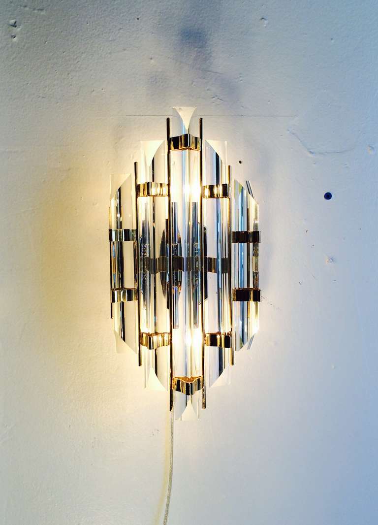 A pair of Murano glass with brass and chrome wall sconces designed by Venini, circa 1960s. 
Newly rewired.