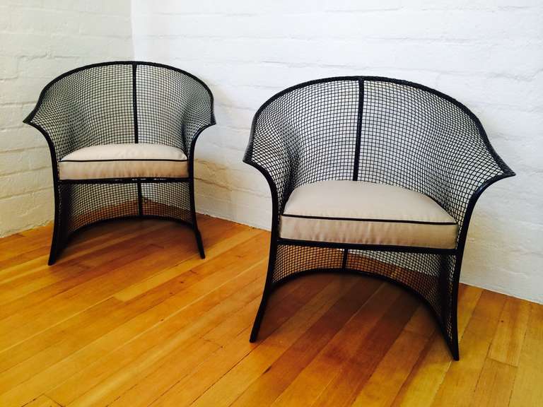 A pair of newly powder coated in black with new cushions mesh metal patio chairs by Russell Woodard. 
Circa 1960s
