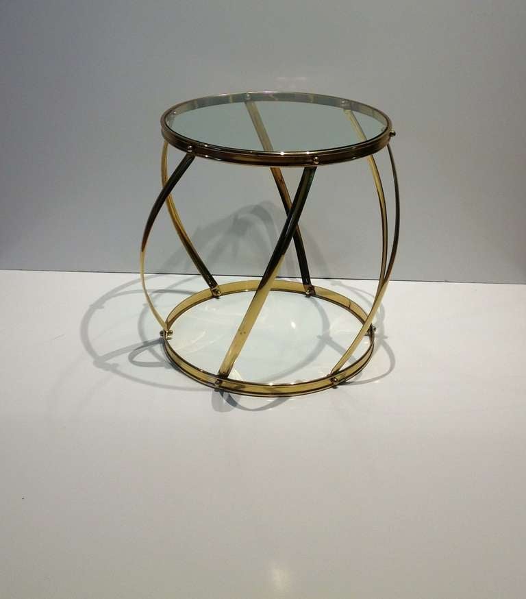 This simple and elegant drum side table is polished bass base with a glass inset top.