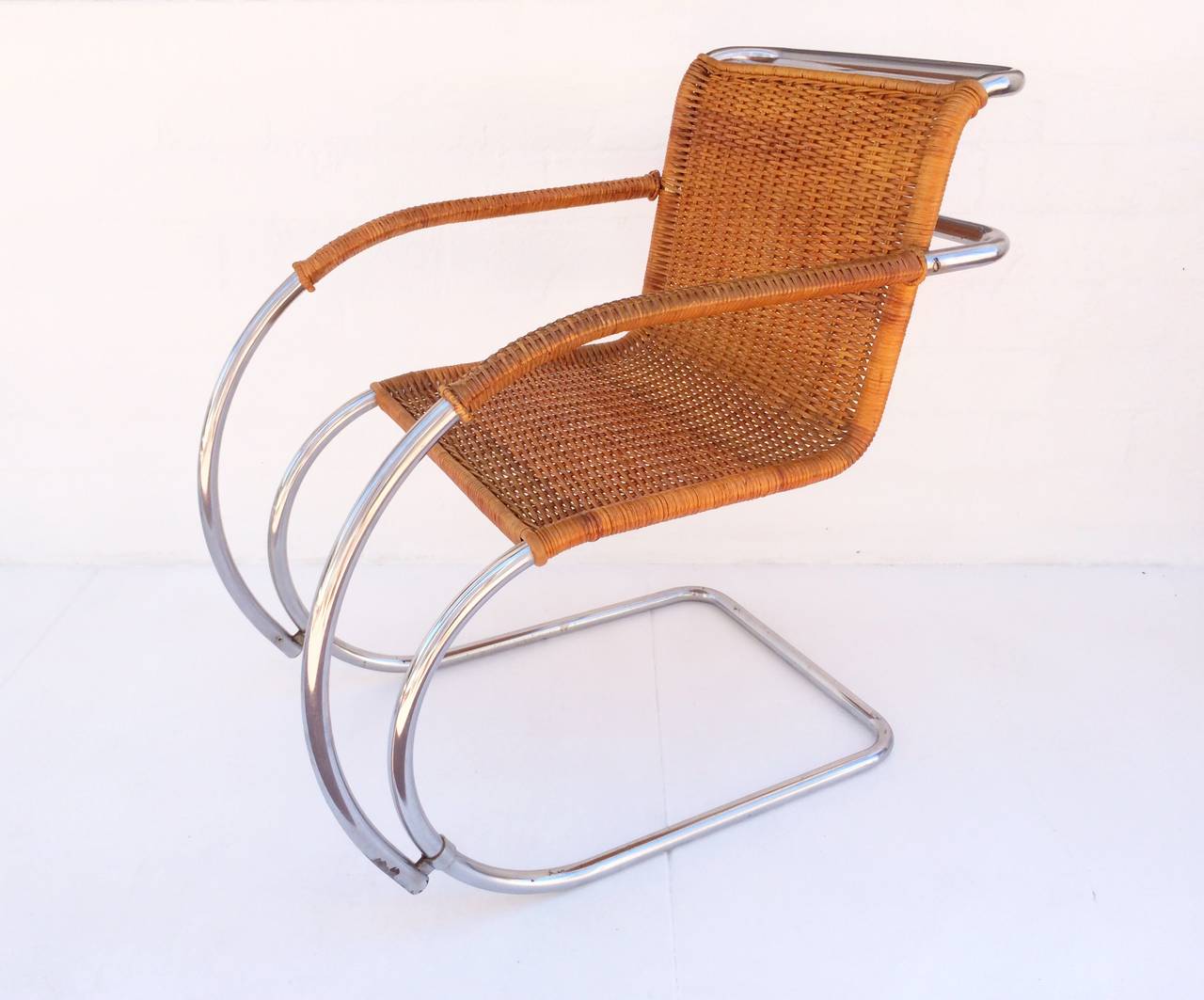 This lounge chair was manufactured in Denmark in the 1960s. 
All the cane is in excellent condition. 
The chrome does show a little wear consistent with age.