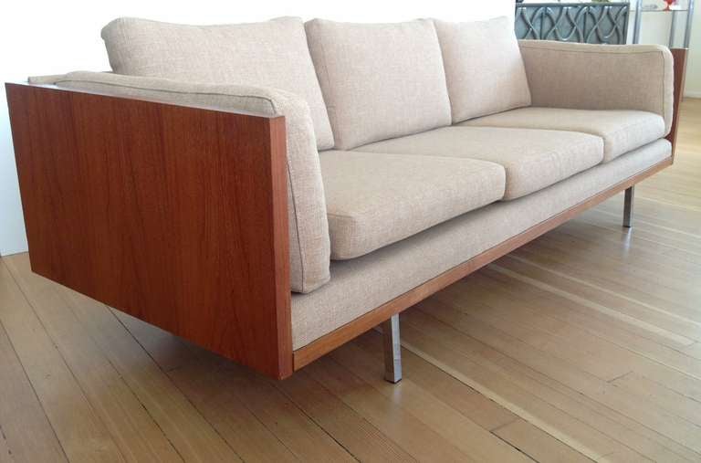 A  wood framed sofa supported on  chrome legs with loose cushions  designed by Milo Baughman.