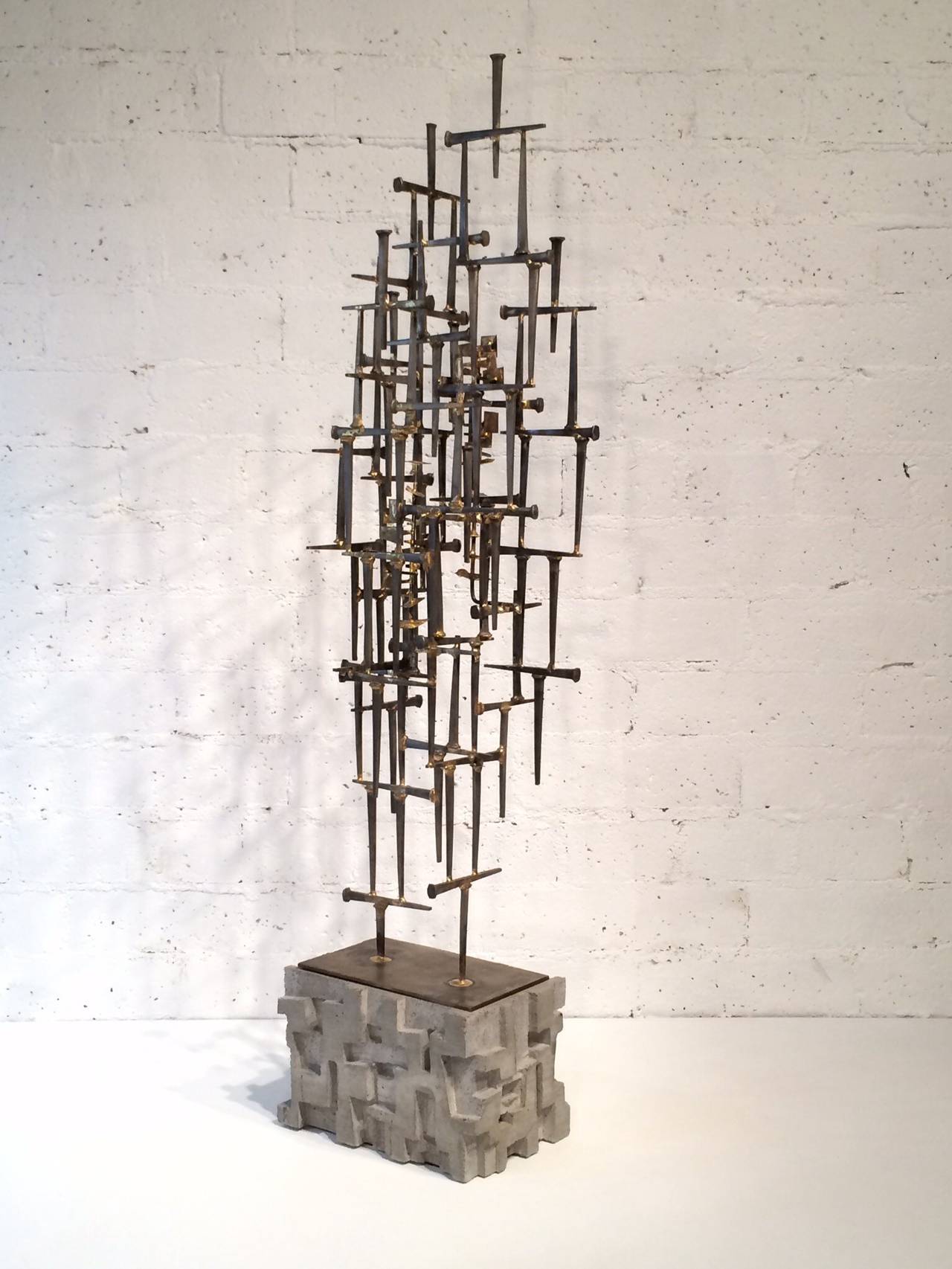 A stunning freestanding nail sculpture by artist Tim Mitchell.  
This sculpture consist of nail sculpture and a cast concrete base. 
The sculpture slides down into the base making shipping easier.