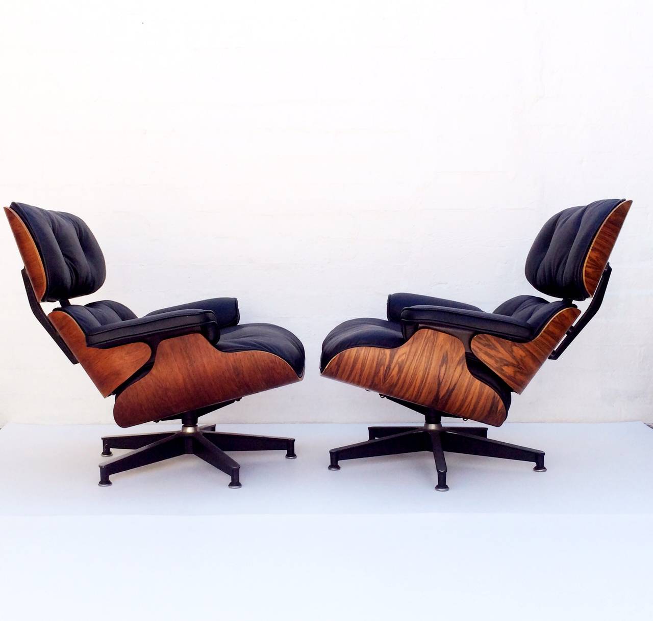 A pair of Eames 670 and 671 rosewood lounge chairs each with matching ottoman.
Down filled with newly reupholstered soft black leather.
These early edition, circa 1950s chairs and ottomans are in amazingly great condition.
Both chairs retain the