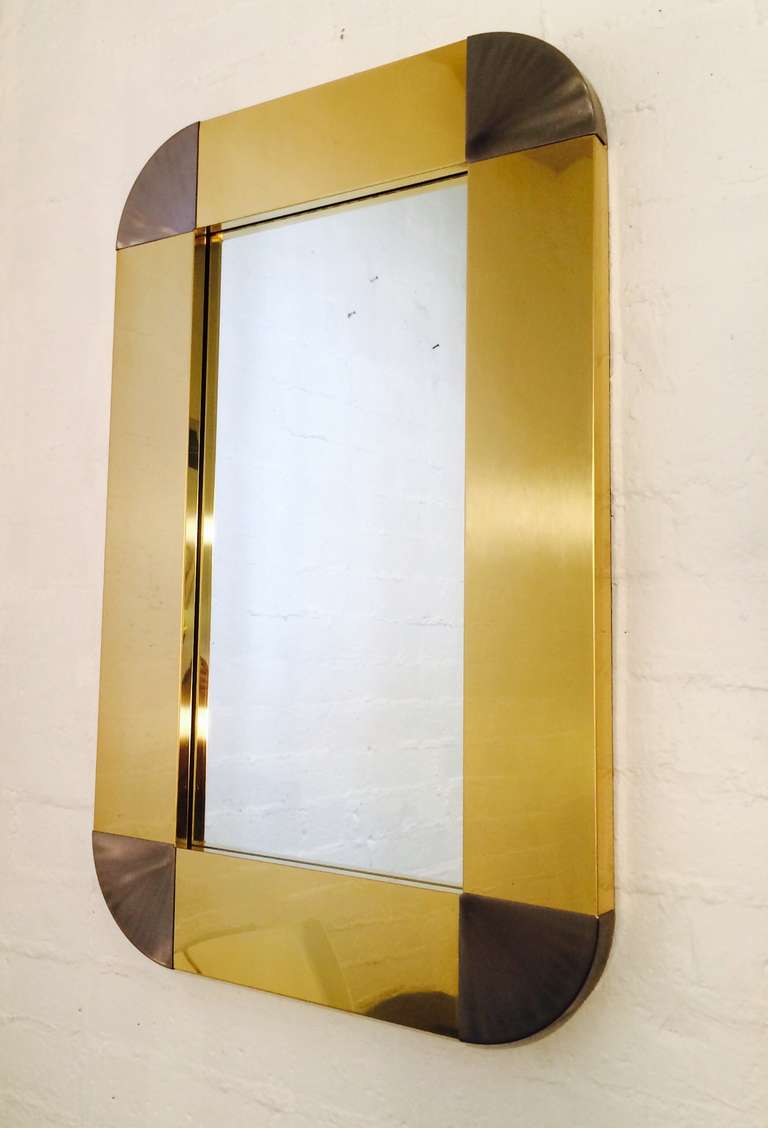 A Polished brass mirror with brushed steel corners by Curtis Jere.
This mirror retains the original label.