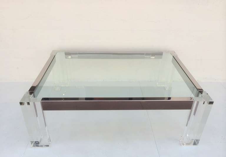 This table consists of acrylic legs and base with polished chrome with a heavy inset glass top. It is signed on one of the legs ( see photo)