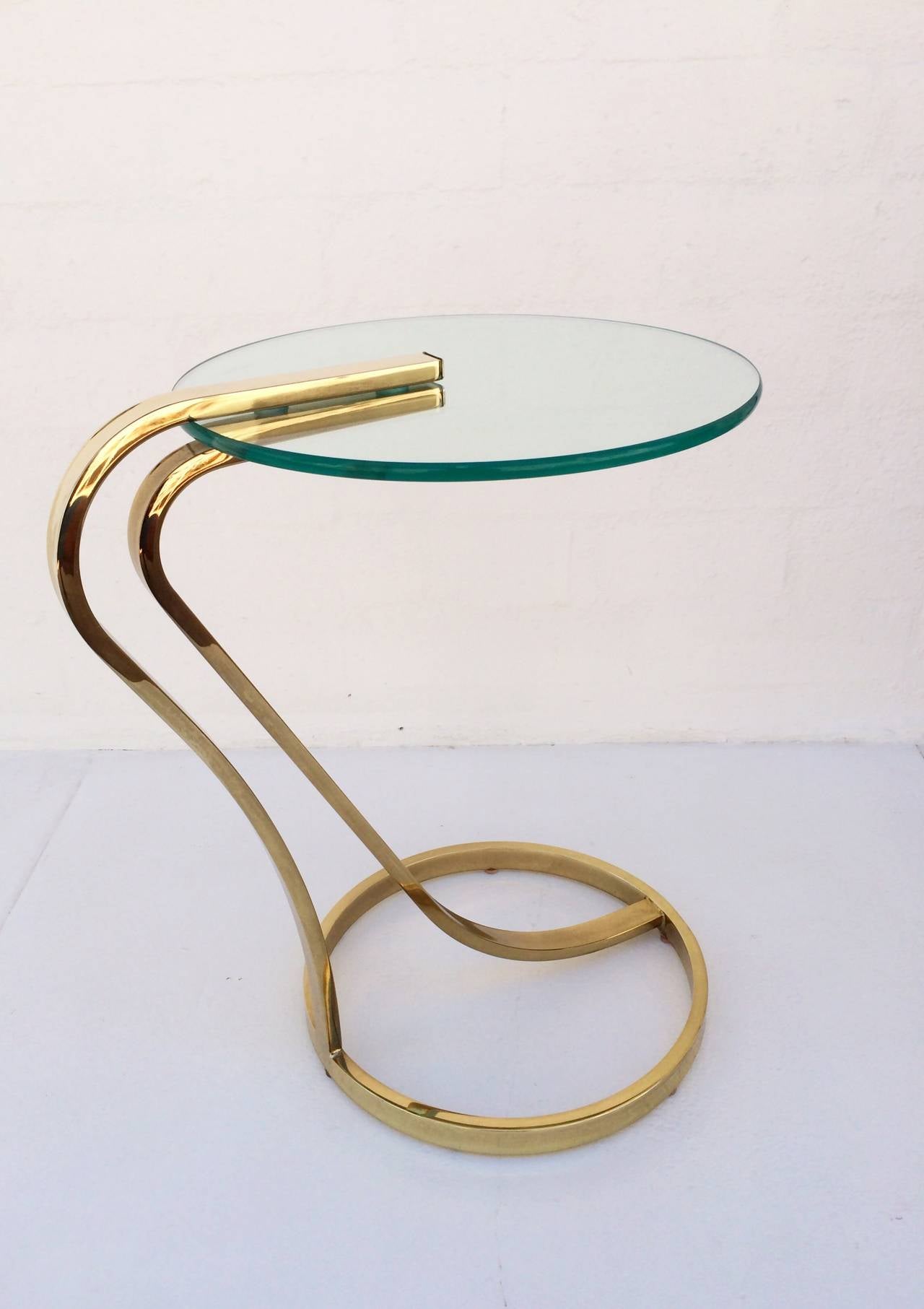 A polished brass and glass occasional table by Milo Baughman for Design Institute of America.  The glass top is 3/8
