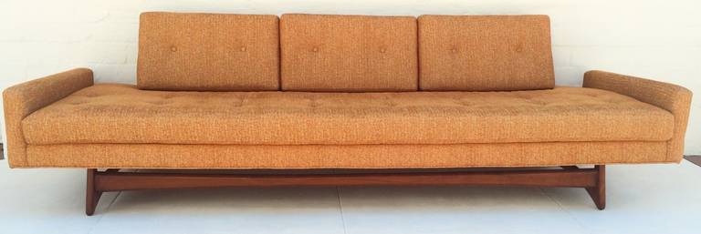 A light burnt orange sofa with walnut base.
Designed by Adrian Pearsall for Craft & Associates.
Circa 1960s