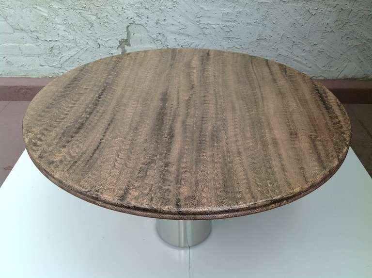 A large faux snakeskin top dining table with a heavy chrome base from Pace Collection.
This table easily seat six people.