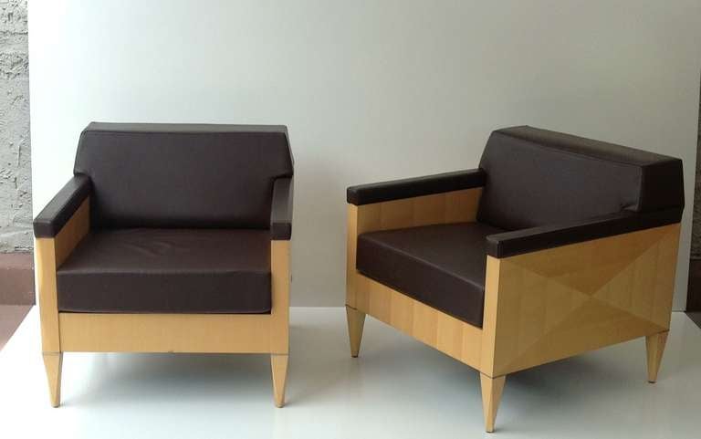 A pair of solid maple lounge chair from Gunlocke designed by Ken Rainhard.
Soft brown leather with a reversible seat cushion.