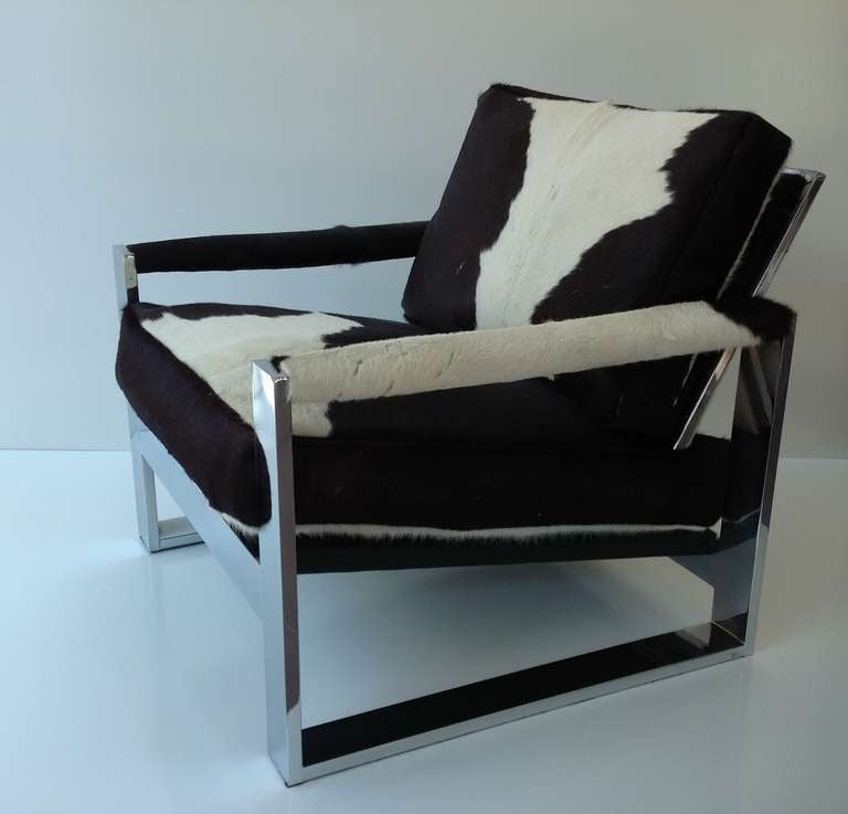 Polished chrome lounge chair covered in cowhide designed by Milo Baughman.
