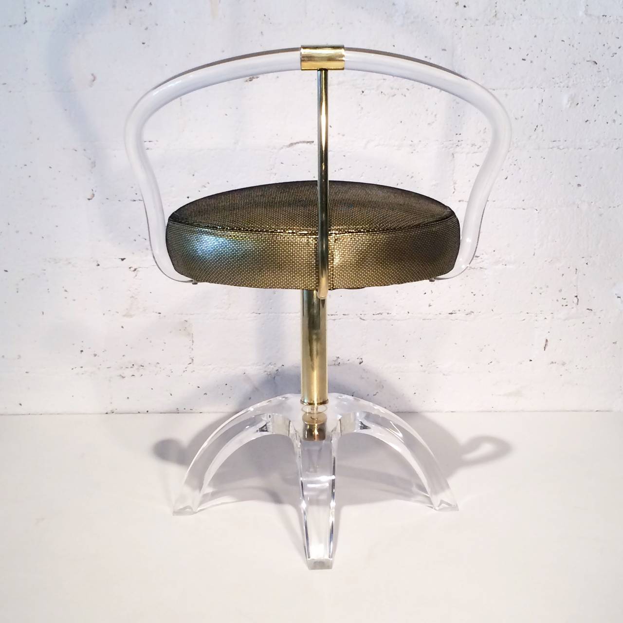 An acrylic swivel vanity stool designed by Charles Hollis Jones. 
This stool design was originally designed by Charles for Lucille Ball.
Consist of acrylic bottom base with four legs that attaches to a polished brass seat pole, the seat in newly