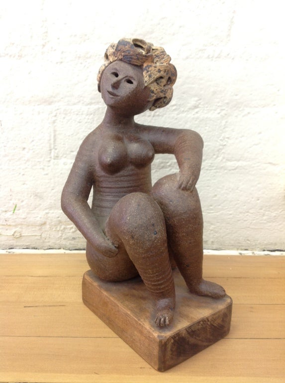 A wonderful example of California artist Cliff Stewart's work.
This pottery sculpture sits on a wood base. She is signed and dated 1961.