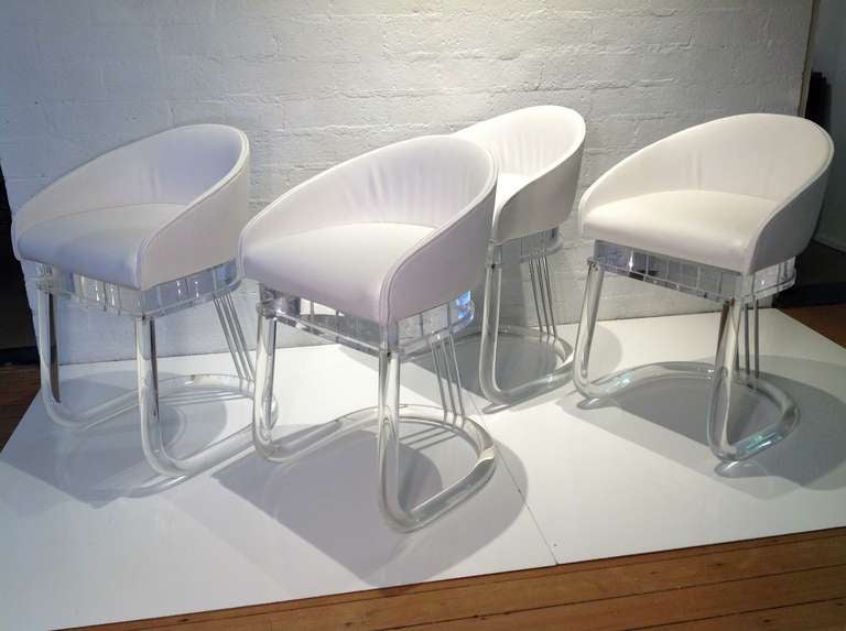 For your consideration, a set of four acrylic dining chairs by Lion in Frost ( signed)
Original white vinyl upholstery seats that swivel.
Three polished chrome rods support the seat.
The acrylic has been professionally polished.