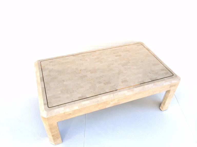 A coffee or cocktail table by Maitland-Smith.
This stunning table is tessellated fossil stone with inlaid brass.