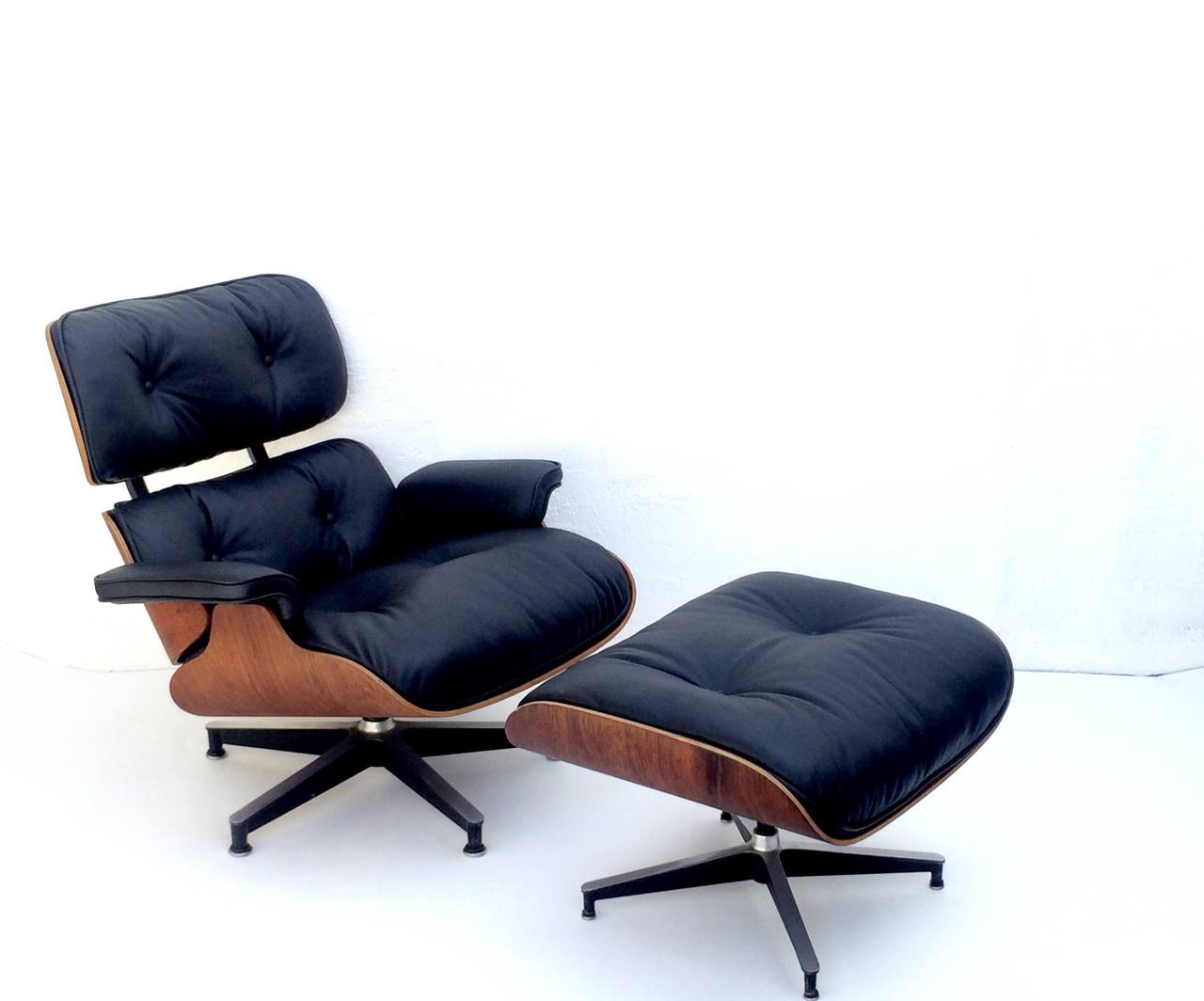 An early 1950s down filled rosewood Eames 670 lounge chair and a 671 ottoman
Chair is 32