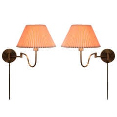A pair of Brushed Brass Touch Control Wall Lamps by Casella