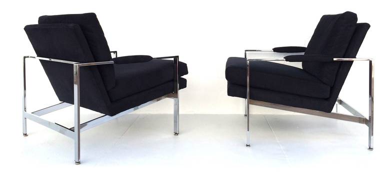 A pair of polished chrome newly reupholstered in a dark navy blue Ultrasuede lounge chairs designed by Milo Baughman for Thayer Coggin Circa 1970s.