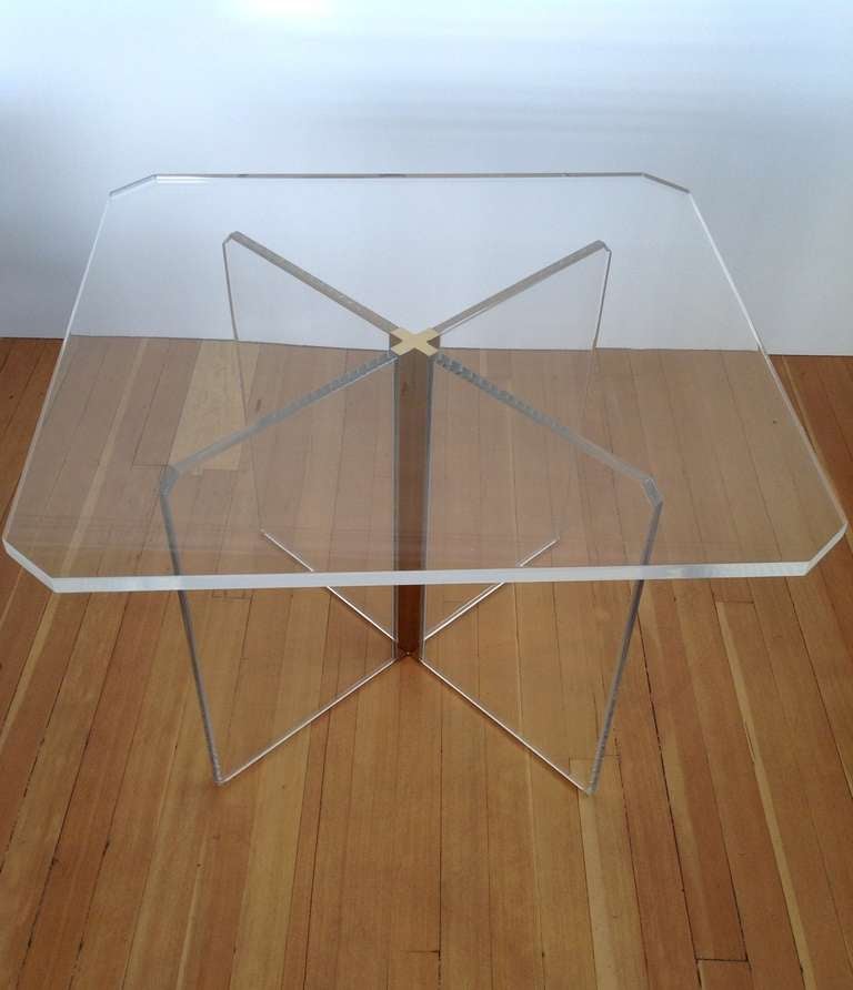 An acrylic dining/game table in the style of Charles Hollis Jones.
This table consist of four large solid acrylic pieces that inset into a polished brass X  column to make the base with a one inch thick solid acrylic top that sets onto it
Was just