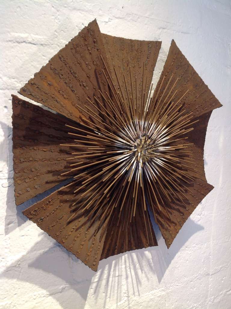 A unique burtalist flower wall sculpture with a gorgeous distress patina  and a hint of white paint in the center from the 1960s