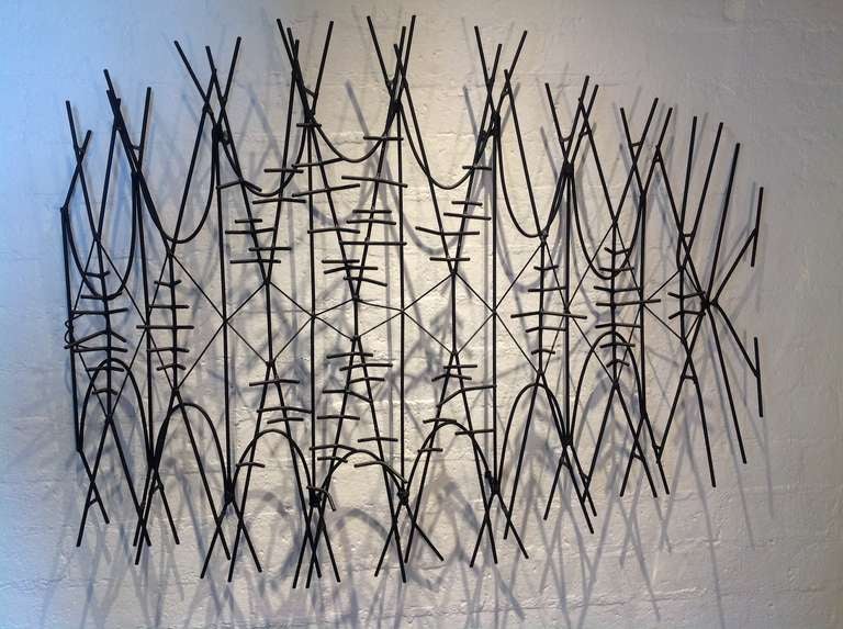 A large black powder coated  metal abstract wall sculpture from the 1950s