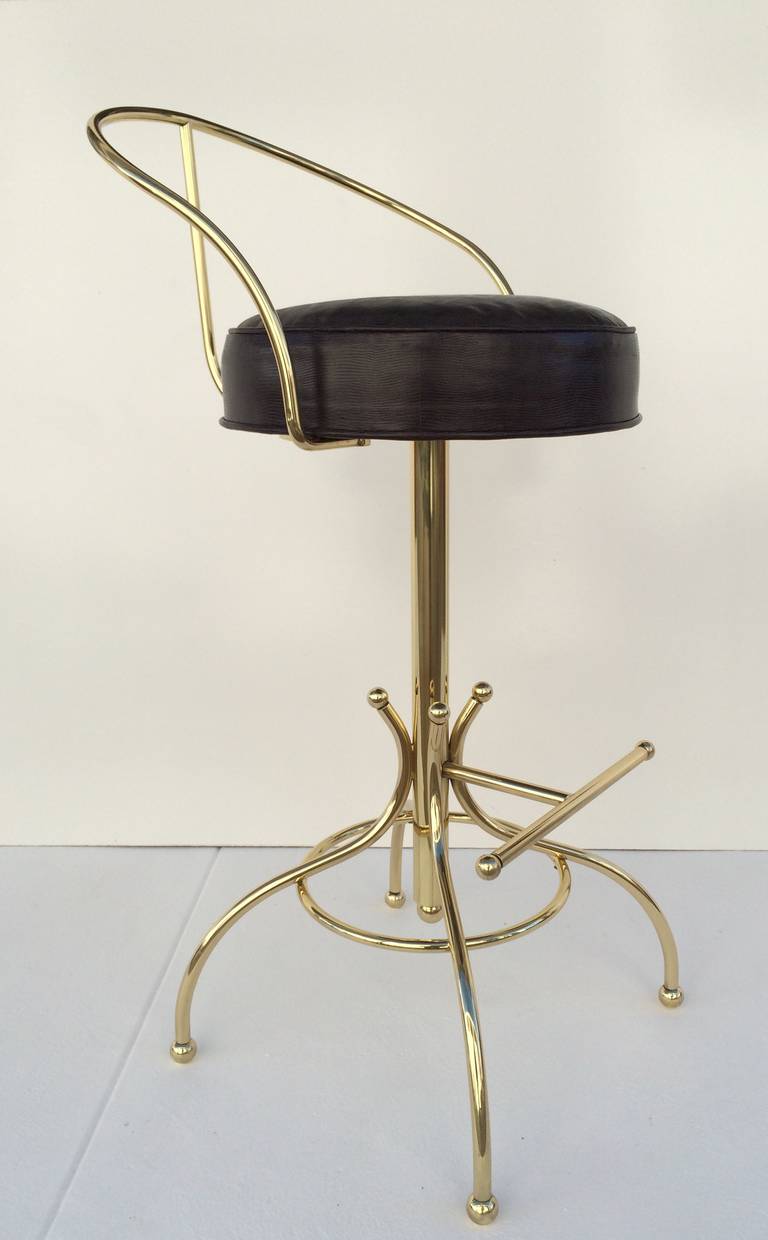Three professionally polish brass swivel barstools with newly reupholster brown faux lizard leather seats designed by Charles Hollis Jones circa 1965 for Hudson Rissman.