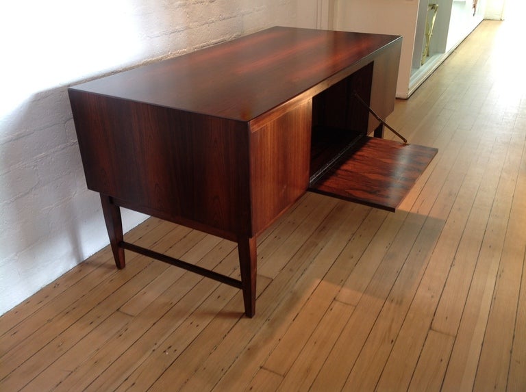 1960s rosewood desk, with locking drop down bar in the front and two locking drawers.
Keyholes are brass.
A key is included.  