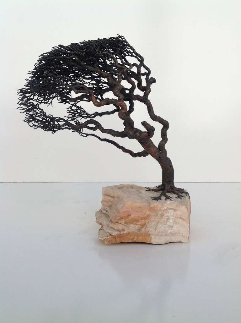 This tree sculpture is bronze mounted on quartz rock.
When you first look at it, you just see the tree, but as you examine it more closely, you will fine a hidden nest on one branch, and a hidden bird on another.
the details are amazing!
It is