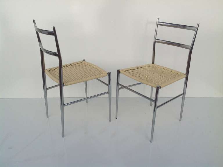 A pair of Italian chrome chairs with woven white plastic seats attributed to Gio Ponti.