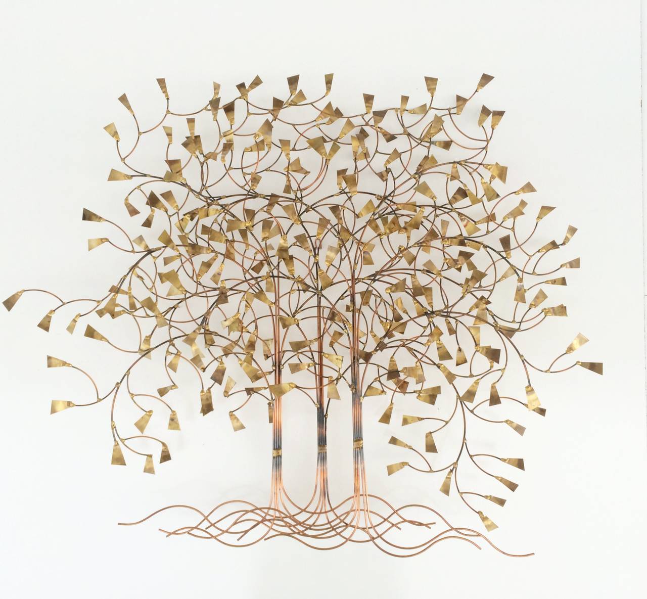 A beautiful copper and brass wall sculpture. The leaves are of brass and the rest is copper.