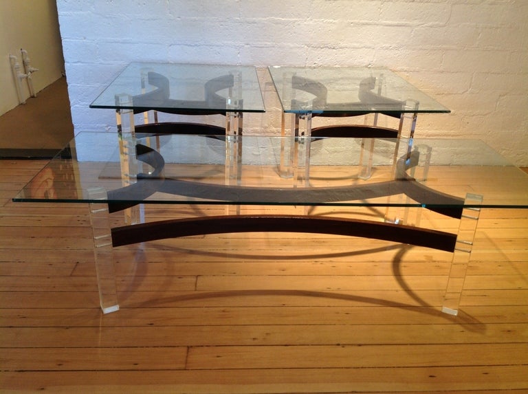 A set of three tables.
 Coffee/cocktail and two end tables.
These have Lucite legs that are held together with Rosewood that support glass tops
Coffee/Cocktail table  15
