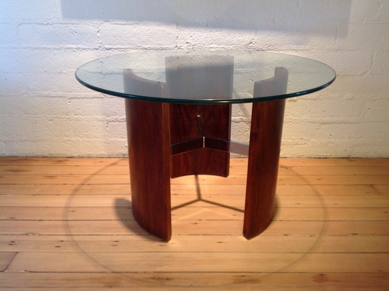 A vintage walnut side table with a chrome plated metal stretcher<br />
The three arched walnut sides are held in place by a Y-shaped armature that gives the appearance that the legs are free-standing.  A circular glass top sits above the arched