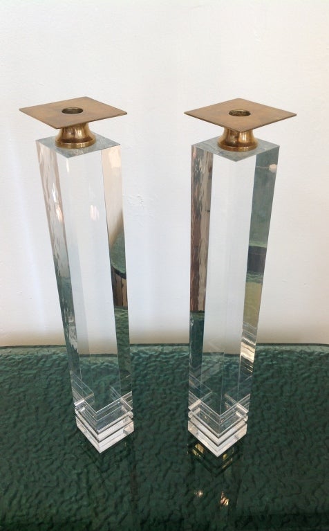 A Stunning pair of lucite candle holders with brass tops. These came from an estate in Indian Wells designed by Stephen Chase.