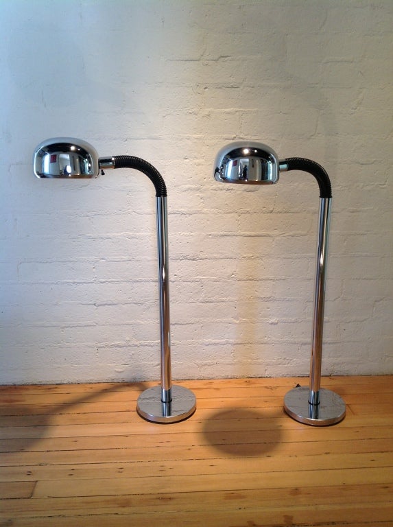 A pair of chrome floor lamps that flex at the top to adjust the light.
The Periscopio light was designed  by Danilo & Corrado Aroldi in 1966. The floor light was produced by Stilnovo in 1972.