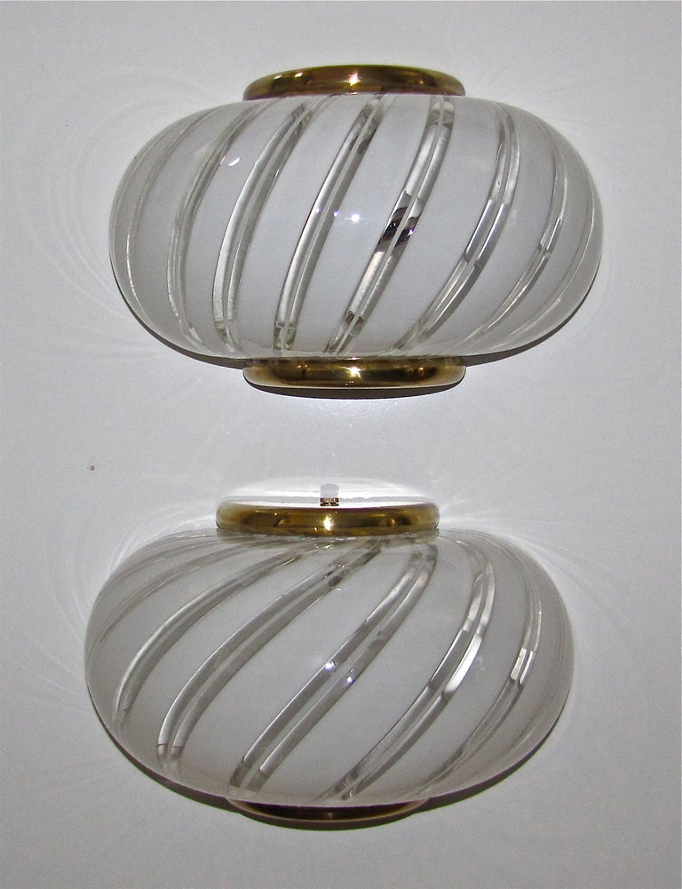 Pair of attractive Murano Italian glass white and clear stripe wall sconces with brass mounting fittings. Newly wired.