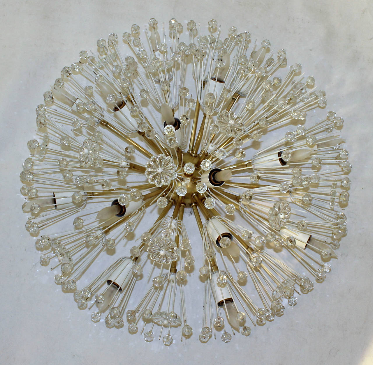 Fantastic large Emil Stejnar snowball flush mount ceiling light constructed of brass with white painted florets and socket covers accented with crystal flowers and beads. Fifteen-light sockets use 25 watt max candelabra base bulbs.
Newly wired.