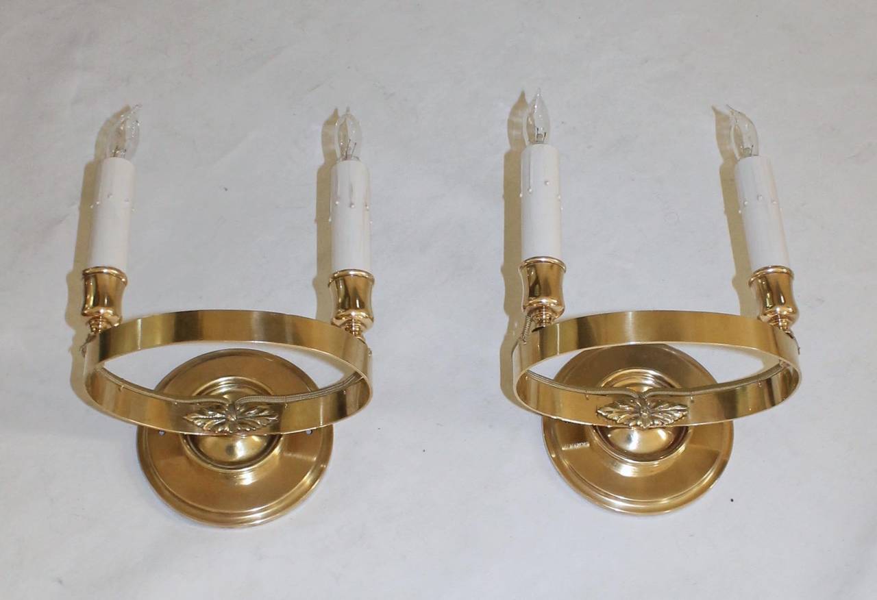French brass 2 light empire style wall sconces. Each uses 2 - 40 watt max candelabra base bulbs. Decorative 4.75