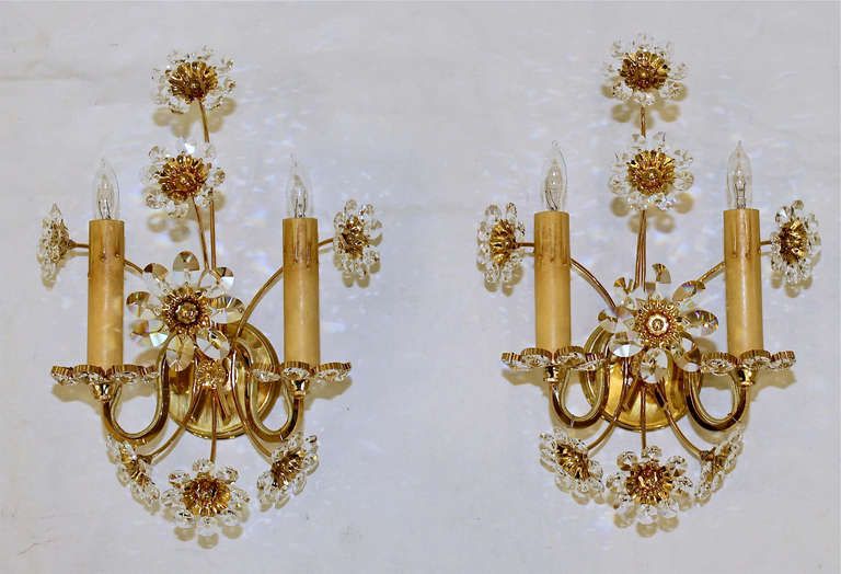 Pair of elegant 2 light floral motif wall sconces with crystals. Back plates are gold plated. Each sconce uses2 - 40 watt candelabra base bulbs. Newly wired.