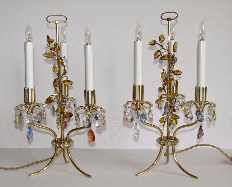 Pair of exquisite Lobmeyr three-light table lamps originally designed by Oswald Haerdtl for the World Exposition in Paris 1937. Made of delicate cut crystal and uniquely formed brass candle sleeves on a light and slender frame with an organic vine