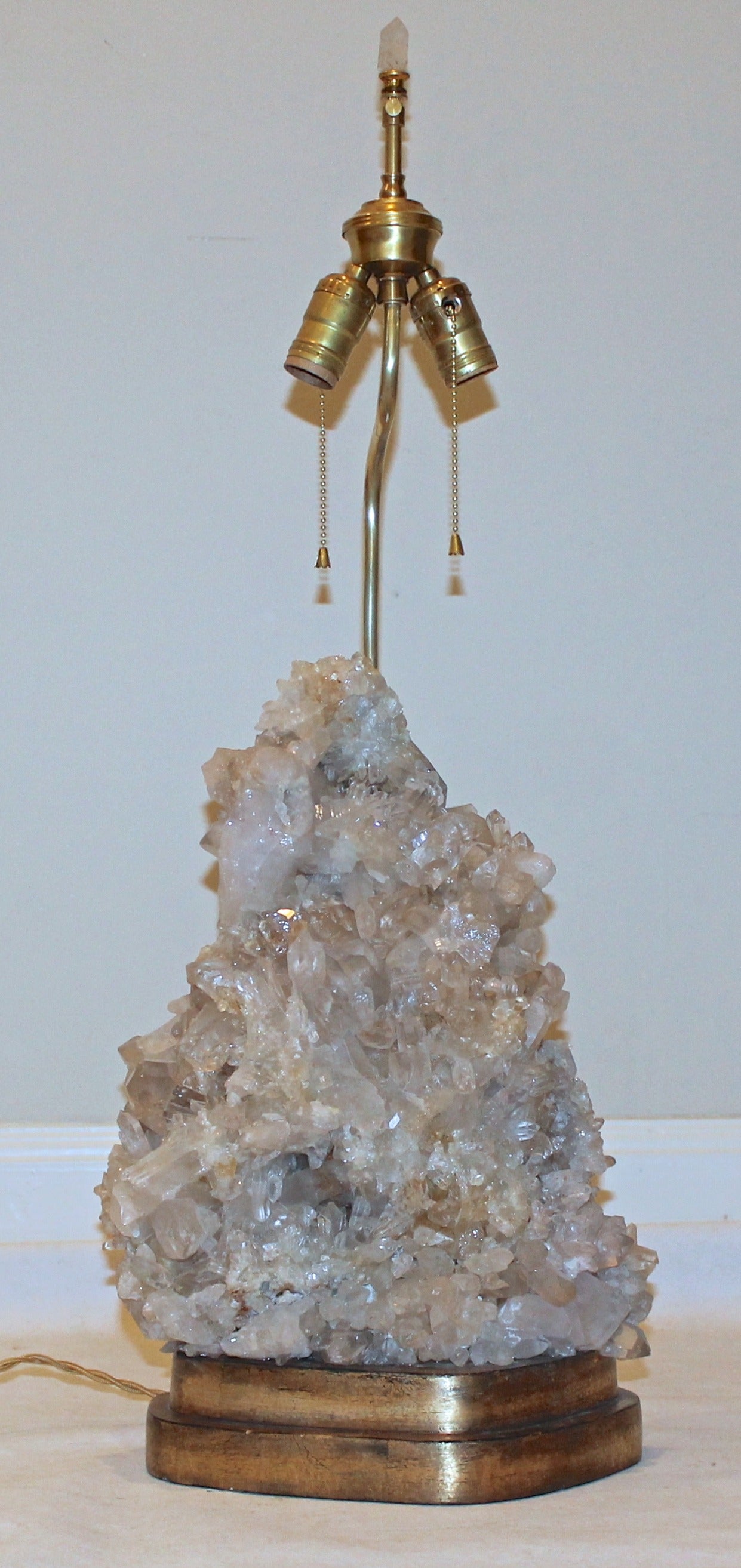 Exceptional quartz crystal table lamp on giltwood base, attributed to Carole Stupell. Brass double cluster sockets and quartz crystal finial, newly wired for the US with French rayon style cord, original brass fittings and on/off double pull