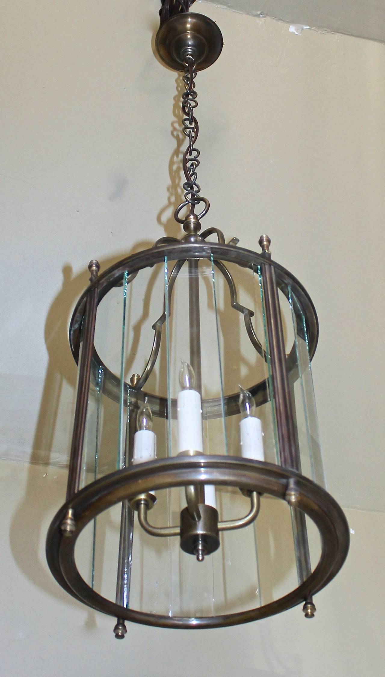 Italian brass Neoclassic brass hall lantern with segmented glass panels. Uses 4 - 40 watt max candelabra base bulbs, newly wired for US. Fixture 11" D x 23" T, total height including chain 40" can be adjusted as needed.

This item is