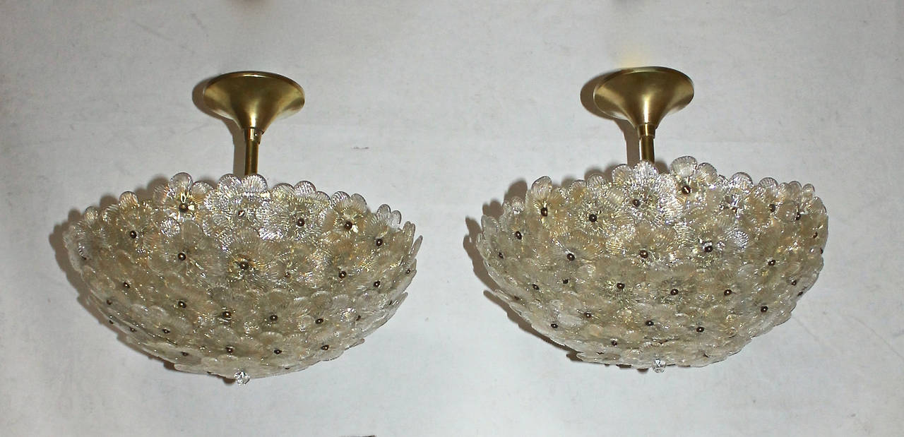 Pair of Barovier Italian floral pendant ceiling lights with brass hardware and ceiling caps. Glass flowers with clear and gold inclusions. Each fixtures uses 3 - 40 watt max candelabra base bulbs. Newly wired. Fixture 13