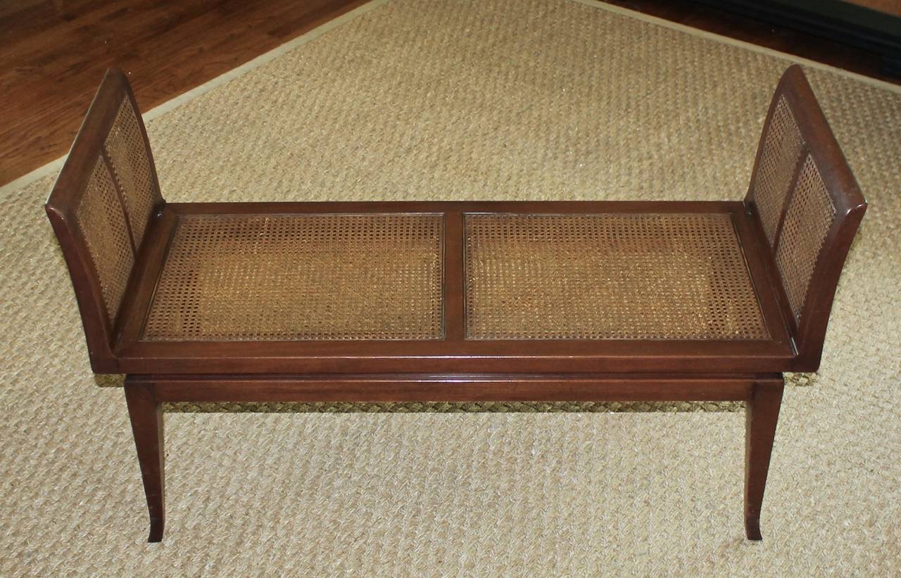 Wood and cane bench with great lines. Made by Fine Arts Furniture, Grand Rapids, MI 1960's. Includes padded seat cover with older upholstery, can easily be recovered to suit.