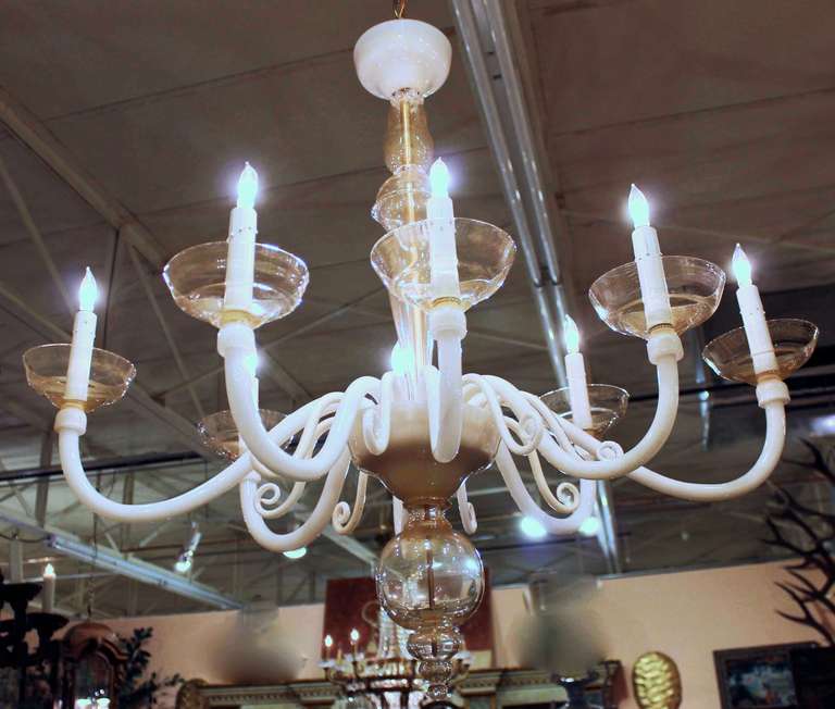 Pair of Murano oval shaped eight-light chandeliers. Composed of cream and clear glass with gold inclusions. Newly wired for US. Overall height with chain and ceiling cap is 47