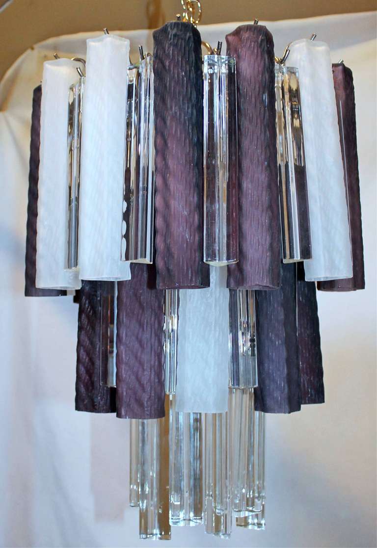 Murano chandelier with combination purple and white matte glass tubes and crystal triedi prisms, suspended on a chrome plated steel frame. Uses 9 - 40 watt max candelabra base bulbs, newly wired.