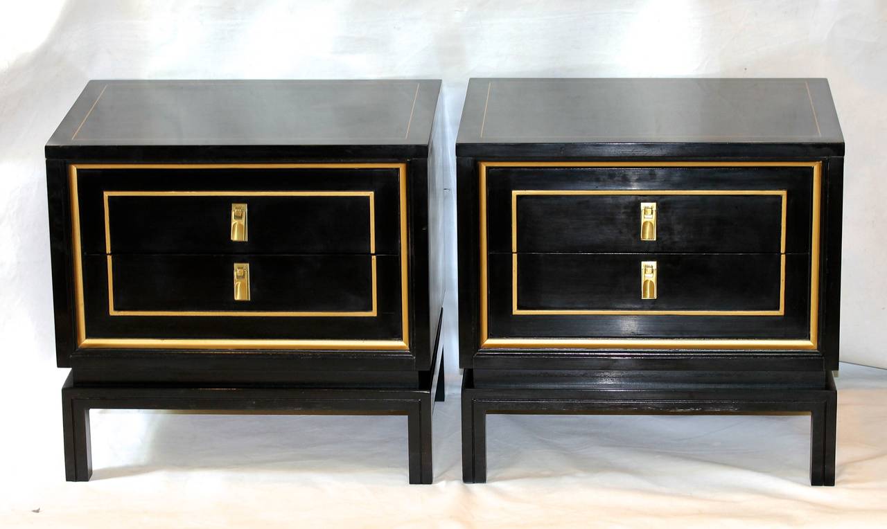 Pair of black lacquered and gold painted detailing night stands or end tables by American of Martinsville. The Dorothy Draper inspired nightstands have attractive brass pulls and 2 pull out drawers. Matching dresser available under separate listing.