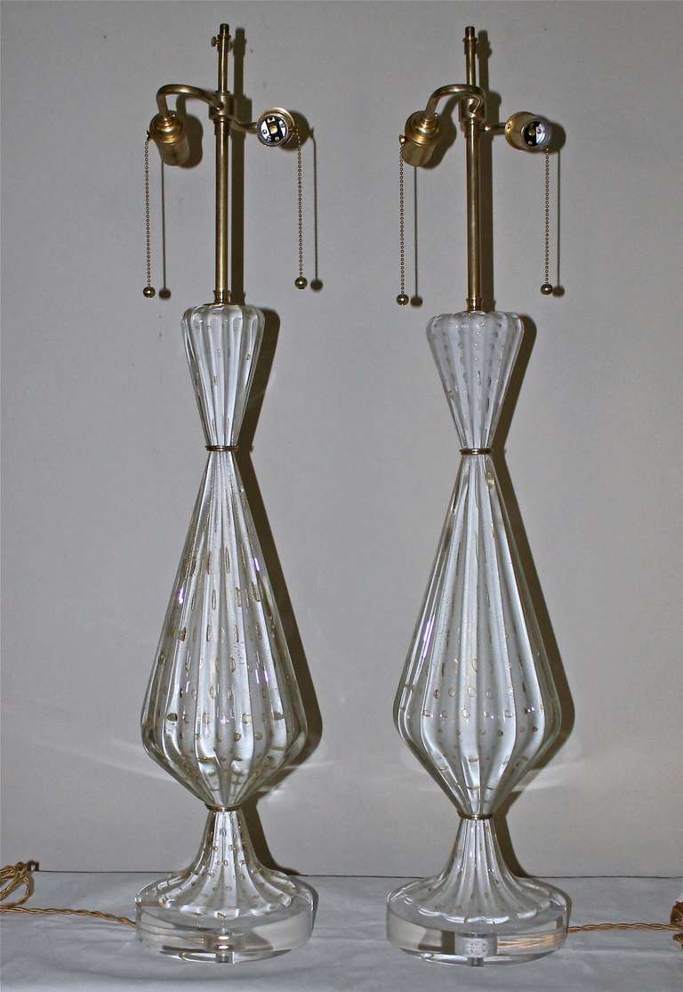 Exceptional pair of tall Murano hand blown white and gold inclusions glass table lamps with controlled bubbles. New custom acrylic base, rewired with brass double cluster on/off pull chain sockets and French style twisted rayon covered cords.