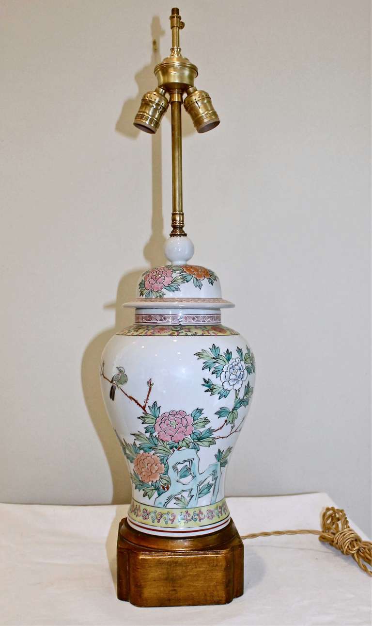 Asian, hand-painted porcelain table lamp mounted on custom giltwood base,  with brass double cluster sockets, and French style twisted rayon covered cords. Newly wired.