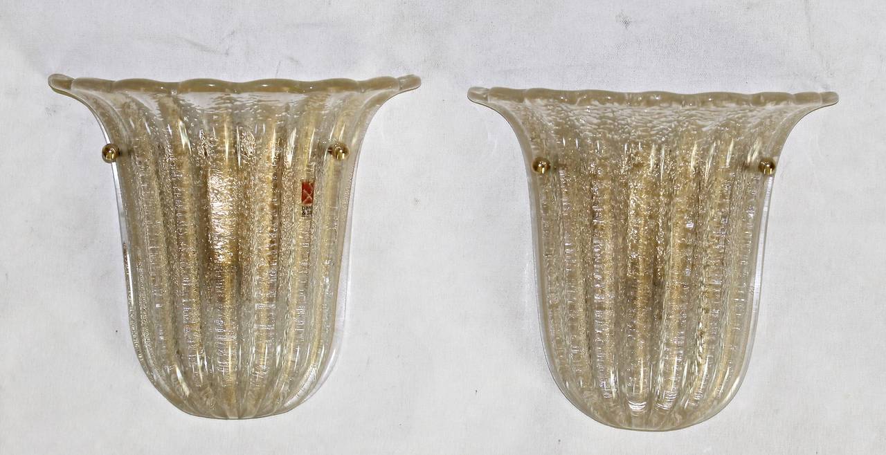 Pair of hand blown ribbed glass wall sconces by Barovier & Toso, Murano. Glass is infused with gold flecks and the reverse side in the 