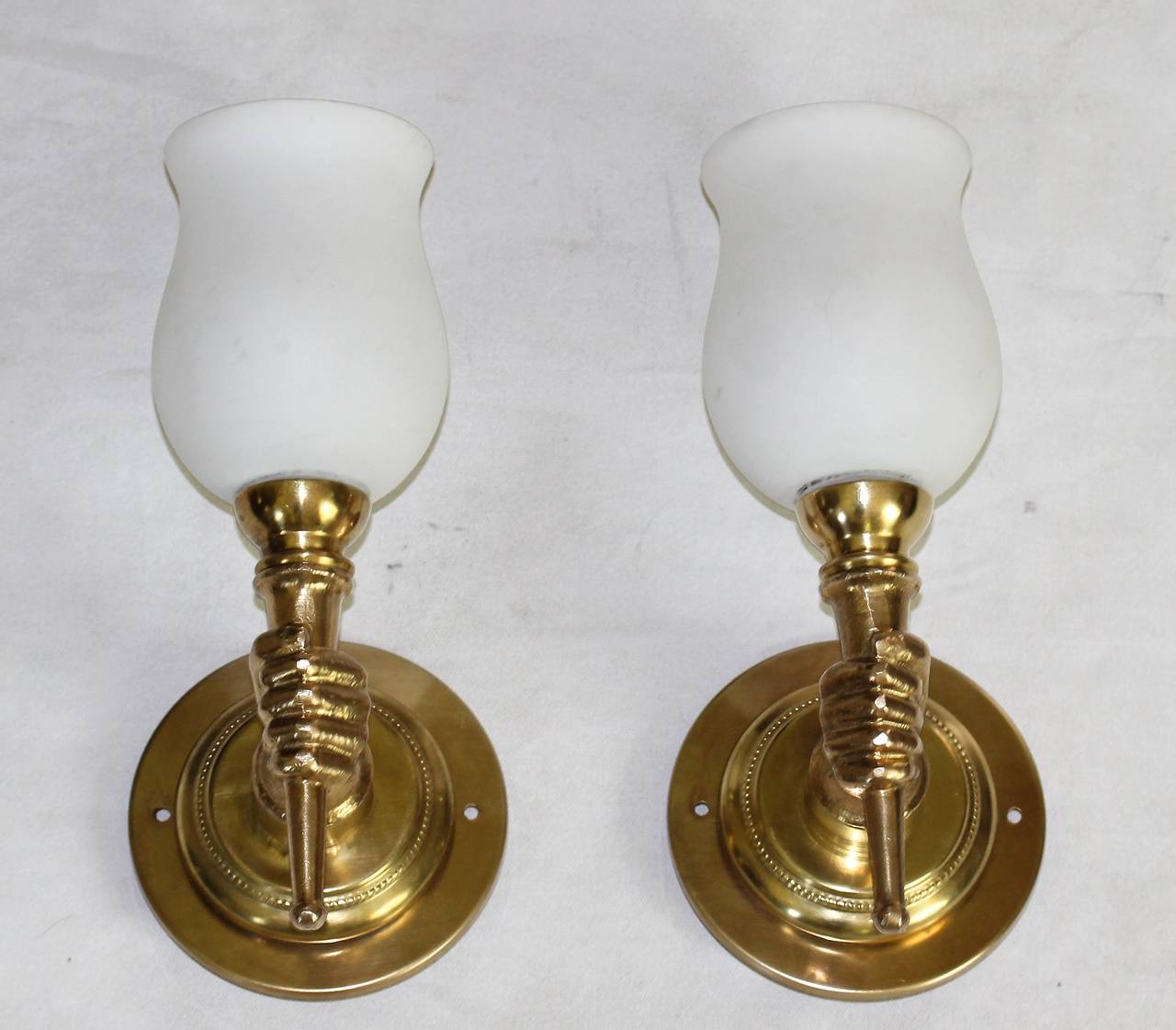hand holding torch wall sconce